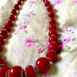 Red beaded necklace, has weight to it, no stretch